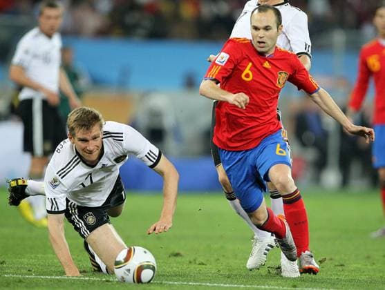 Andres Iniesta (R) of Spain and Per Mertesacker of Germany during the World Cup Semifinal between Germany and Spain on July 7, 2010 at the Moses Mabhida Stadium in Durban. ( Gallo0000119954