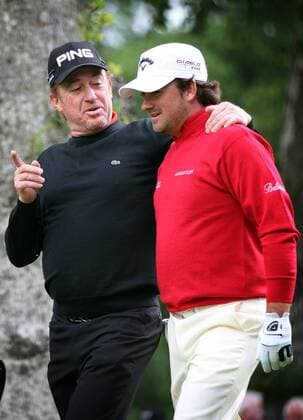 Golf - Loch Lomond - Barclays Scottish Open - Miguel Angel Jimenez (ESP, L) and Graeme McDowell (Northern Ireland) share a joke after teeing off at the 10th. 