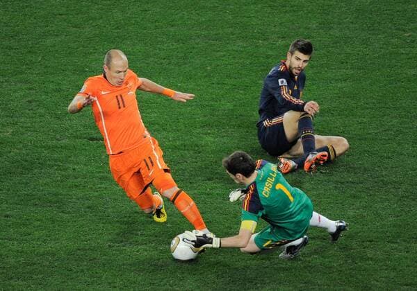 11 July 2010: Spain goalkeeper Iker Casillas (1) steals the ball away from Dutch midfielder Arjen Robben (11) as defender Gerard Pique (3) watches on during the World Cup Final between Holland and Spain at Soccer City in the FIFA World Cup 2010. Icon010100711150 EDITORIAL USE ONLY