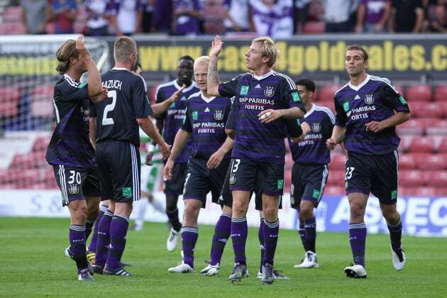 Football - UEFA Champions League 3rd Qualifying Round - The New Saints FC (white green) vs. RSC Anderlecht (blue black) --- Anderlecht s Jonathan Legear (2R) celebrates scoring his sides 2nd goal of the night at the Racecourse Ground, Wrexham 
