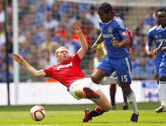 Paul Scholes (L) of Manchester United tackles Florent Malouda of Chelsea Community Shield - FC Chelsea v Manchester United (red) , 8th August, 2010 - EDITORIAL USE ONLY. No use with unauthorised audio, video, data, fixture lists, club league logos or live services. Online in-match use limited to 120 images, no video emulation. No use in betting, games or single club league player publications. o0 ManU