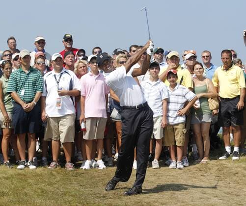 The gallery watches as Tiger Woods (USA) follows through on his approach shot on the 2nd hole during the first round of the 92nd PGA Championship at Whistling Straits in Kohler, Wisconsin on August 12, 2010.  BKX2010081213