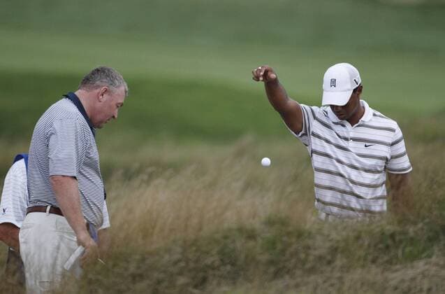 Tiger Woods (USA) (R) takes a drop on the 5th hole during the second round of the 92nd PGA Championship at Whistling Straits in Kohler, Wisconsin on August 13, 2010. Woods received a free drop after he needed to touch his ball in order to identify it. The second round was suspended due to darkness.  BKX2010081346