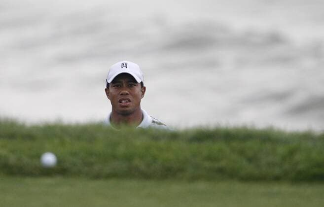 Tiger Woods (USA) watches his chip shot land on the green on the 3rd hole during the second round of the 92nd PGA Championship at Whistling Straits in Kohler, Wisconsin on August 13, 2010. The second round was suspended due to darkness.  BKX2010081343