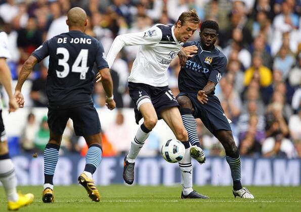 Peter Crouch (C) of Tottenham Hotspur holds off Kolo Toure of Manchester City Barclays Premier League Tottenham Hotspur v Manchester City 14th August, 2010 EDITORIAL USE ONLY. No use with unauthorised audio, video, data, fixture lists, club league logos or live services. Online in-match use limited to 120 images, no video emulation. No use in betting, games or single club league player publications.