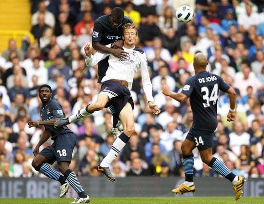 Peter Crouch (C)of Tottenham Hotspur and Micah Richards of Manchester City leap for the ball Barclays Premier League Tottenham Hotspur v Manchester City 14th August, 2010 EDITORIAL USE ONLY. No use with unauthorised audio, video, data, fixture lists, club league logos or live services. Online in-match use limited to 120 images, no video emulation. No use in betting, games or single club league player publications.