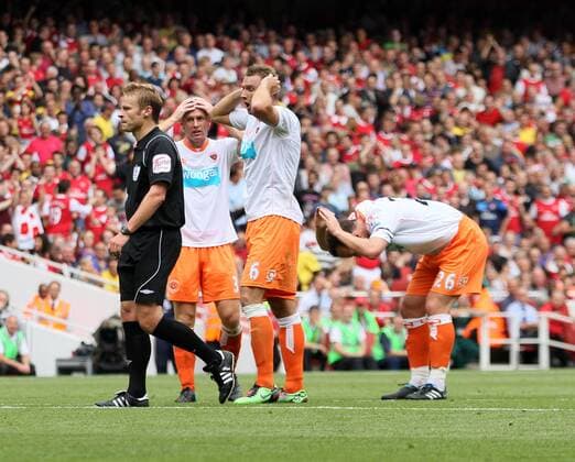 Blackpool FC s Ian Evatt (2R) gets sent off for a tackle by referee Mike Jones Barclays Premier League Arsenal London (red) v Blackpool FC (white) 21st August, 2010 EDITORIAL USE ONLY. No use with unauthorised audio, video, data, fixture lists, club league logos or live services. Online in-match use limited to 120 images, no video emulation. No use in betting, games or single club league player publications.