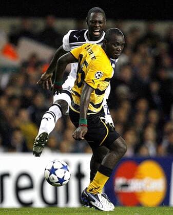 Henri Bienvenu Ntsama of Young Boys holds off Ledley King of Tottenham Hotspur UEFA Champions League Qualifying - Tottenham Hotspur (white) vs. BSC Young Boys Bern (yellow) - 25th August, 2010 EDITORIAL USE ONLY. No use with unauthorised audio, video, data, fixture lists, club league logos or live services. Online in-match use limited to 120 images, no video emulation. No use in betting, games or single club league player publications.