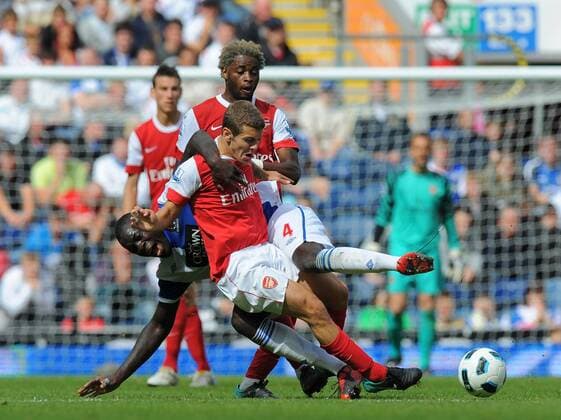 Jack Wilshere of Arsenal holds off Christopher Samba of Blackburn Rovers - Barclays Premier League - Blackburn Rovers v FC Arsenal (red) 28th August, 2010 EDITORIAL USE ONLY. No use with unauthorised audio, video, data, fixture lists, club league logos or live services. Online in-match use limited to 120 images, no video emulation. No use in betting, games or single club league player publications.