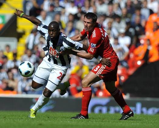 Jamie Carragher (R) of Liverpool challenged by Marco Fortune of West Bromwich Albion Barclays Premier League - Liverpool FC vs. West Bromwich Albion - 29th August, 2010 EDITORIAL USE ONLY. No use with unauthorised audio, video, data, fixture lists, club league logos or live services. Online in-match use limited to 120 images, no video emulation. No use in betting, games or single club league player publications.