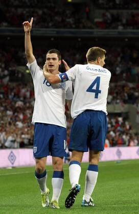 England (white) v Bulgaria (red) . . 03.09.10: Adam Johnson (L) celebrates scoring the third England goal with Steven Gerrard. 3-0 