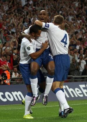 England (white) v Bulgaria (red) . . 03.09.10: Theo Walcott (L) and Steven Gerrard (R) congratulate Jermain Defoe after Defoe opened the scoring for England. 1-0 