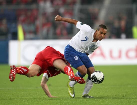 Switzerland s Reto Ziegler (L) tussles with England s Theo Walcott European Championship Qualifying Group G Switzerland v England 7th September, 2010 EDITORIAL USE ONLY. No use with unauthorised audio, video, data, fixture lists, club league logos or live services. Online in-match use limited to 120 images, no video emulation. No use in betting, games or single club league player publications.