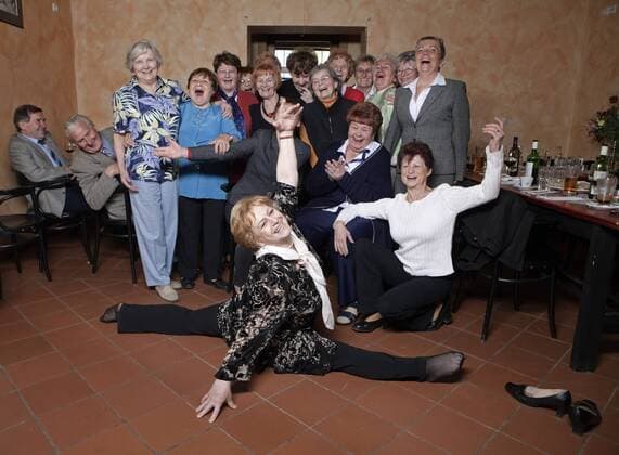 Vera Caslavska (CZE), former gymnast and Coach, who won seven Olympic gold medals in gymnastics, shows her gymnastic skills at celebration of 80th birthday of her former trainer Jaroslava Matlochova-Rybnikarova, April 22, 2010. Pictured, left to right, Antonin Cmiral and Jindoich Mikulec; (upper row left to right) Libuse Houdkova, Alena Danisova, xx, xx, Hana Marejkova-Krausova, Vlasta Janebova, Alena Tinterova-Prorokova, Alena Reichova-Zamostna, Matylda Sinova-Ruzickova, Vera Vancurova-Rylichova, Hana Bobkova-Vlacilova, Libuse Honzikova-Cmiralova and Blanka Pospisilova; (lower row left to righ) Bohumila Rimnacova-Resakova, Jaroslava Matlochova-Rybnikarova and Jindra Kostalova. (CTKxPhoto MartinxSterba,xJosefxHorazny)  CTKPhoto201008310200901