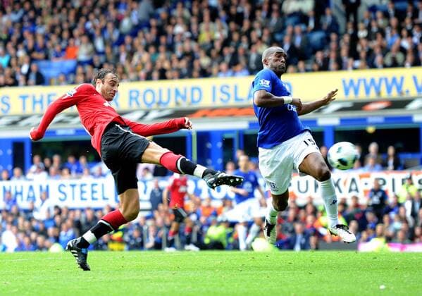 Dimitar Berbatov (L) of Manchester United volleys a shot past Sylvain Distin of FC Everton - Barclays Premier League, FC Everton vs. Manchester United 11th September, 2010 EDITORIAL USE ONLY. No use with unauthorised audio, video, data, fixture lists, club league logos or live services. Online in-match use limited to 120 images, no video emulation. No use in betting, games or single club league player publications. o0 Liverpool Manu