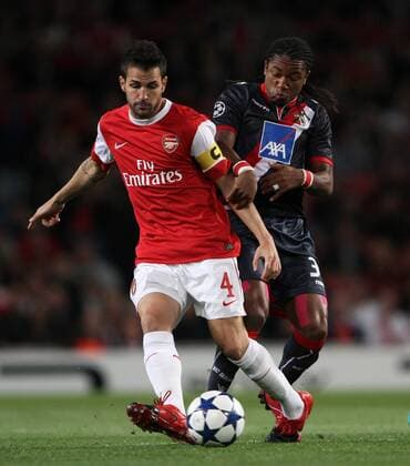 Arsenal s Cesc Fabregas tussles with Braga s Alan --- UEFA Champions League - Group H - FC Arsenal London (red) vs SC Sporting Braga (black), 15th September, 2010 EDITORIAL USE ONLY. No use with unauthorised audio, video, data, fixture lists, club league logos or live services. Online in-match use limited to 120 images, no video emulation. No use in betting, games or single club league player publications.