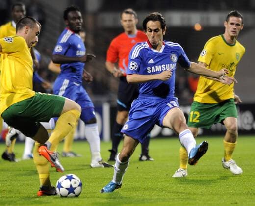Zilina s Lubomir Guldan (left) and Chelsea s Yossi Benayoun fight for the ball during the Champions League Group F soccer match between MSK Zilina (yellow) and FC Chelsea London (blue) in Zilina, on Wednesday, Sept. 15, 2010. Robert Jez looks on the right. (CTKxPhoto JanxKoller)  CTKPhoto8201009150954401