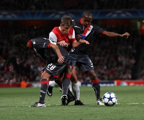 Arsenal FC London s Andrey Arshavin (C) tries to go past Braga s Silvio (R) and Moises UEFA Champions League Group H Arsenal FC London v SC Sporting Braga 15th September, 2010 EDITORIAL USE ONLY. No use with unauthorised audio, video, data, fixture lists, club league logos or live services. Online in-match use limited to 120 images, no video emulation. No use in betting, games or single club league player publications.