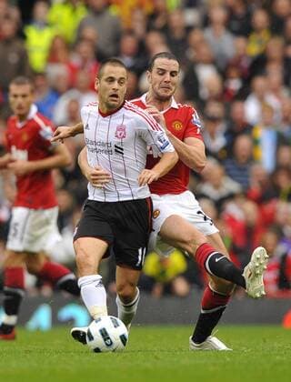 Joe Cole l. of Liverpool FC tackled by John O Shea of Manchester United Barclays Premier League Manchester United Manu v Liverpool FC 19th September, 2010 EDITORIAL USE ONLY. No use with unauthorised audio, video, data, fixture lists, club league logos or live services. Online in-match use limited to 120 images, no video emulation. No use in betting, games or single club league player publications.