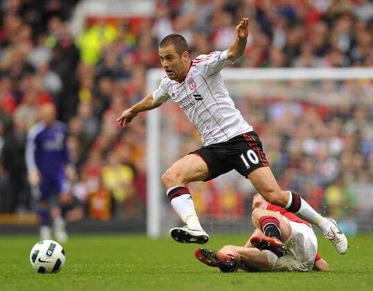 Joe Cole l .of Liverpool FC skips past Paul Scholes of Manchester United Barclays Premier League Manchester United Manu v Liverpool FC 19th September, 2010 EDITORIAL USE ONLY. No use with unauthorised audio, video, data, fixture lists, club league logos or live services. Online in-match use limited to 120 images, no video emulation. No use in betting, games or single club league player publications.