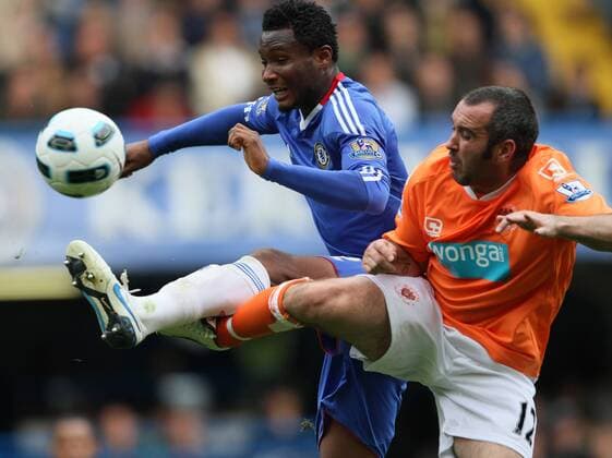 Chelsea s John Obi Mikel (L) tussles with Blackpool s Gary Taylor-Fletcher - Barclays Premier League Chelsea FC London - Blackpool FC - EDITORIAL USE ONLY. No use with unauthorised audio, video, data, fixture lists, club league logos or live services. Online in-match use limited to 120 images, no video emulation. No use in betting, games or single club league player publications.