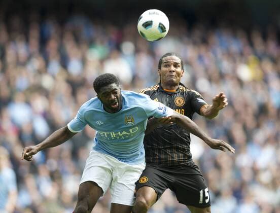 Kolo Toure of Manchester City clears under pressure from Florent Malouda of FC Chelsea Barclays Premier League Manchester City v FC Chelsea 25th September, 2010 EDITORIAL USE ONLY. No use with unauthorised audio, video, data, fixture lists, club league logos or live services. Online in-match use limited to 120 images, no video emulation. No use in betting, games or single club league player publications.