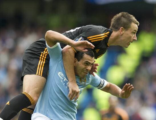 John Terry of Chelsea (top) clashes with winning goalscorer Carlos Tevez of Manchester City - Premier League - Manchester City - Chelsea FC London 1:0 - 2010 EDITORIAL USE ONLY. No use with unauthorised audio, video, data, fixture lists, club league logos or live services. Online in-match use limited to 120 images, no video emulation. No use in betting, games or single club league player publications.