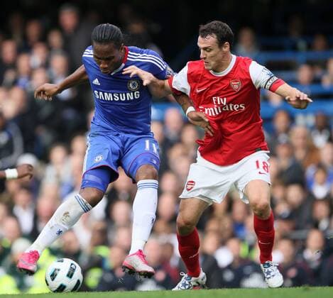 Chelseas Didier Drogba tussles with Arsenals Sebastian Squillaci --- Premier League 2010 2011 - FC Chelsea London (blue) vs FC Arsenal London (red), 3rd October, 2010 EDITORIAL USE ONLY. No use with unauthorised audio, video, data, fixture lists, club league logos or live services. Online in-match use limited to 120 images, no video emulation. No use in betting, games or single club league player publications.