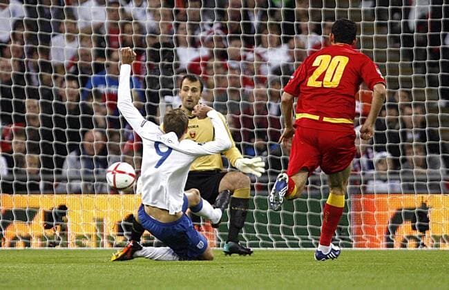 Peter Crouch of England misses a chance vs goalkeeper Mladen Bozovic of Montenegro, European Championship Qualifying Group G England v Montenegro 12th October, 2010 EDITORIAL USE ONLY. No use with unauthorised audio, video, data, fixture lists, club league logos or live services. Online in-match use limited to 120 images, no video emulation. No use in betting, games or single club league player publications.