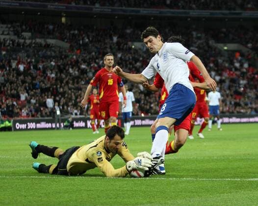 Englands Gareth Barry (R) tussles with Montenegros Mladen Bozovic European Championship Qualifying Group G England v Montenegro 12th October, 2010 EDITORIAL USE ONLY. No use with unauthorised audio, video, data, fixture lists, club league logos or live services. Online in-match use limited to 120 images, no video emulation. No use in betting, games or single club league player publications.