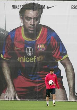 Ciutat Esportiva Joan Gamper (training facility) of FC Barcelona. Lionel Messi in front of a billboard with Xavi Hernandez 
