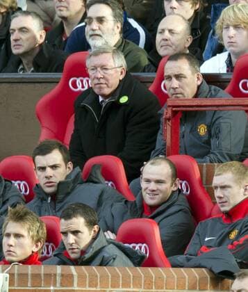 Sir Alex Ferguson coach of Manchester United watches the match along with Wayne Rooney (C) of Manchester United Barclays Premier League Manchester United v West Bromwich Albion 16th October, 2010 EDITORIAL USE ONLY. No use with unauthorised audio, video, data, fixture lists, club league logos or live services. Online in-match use limited to 120 images, no video emulation. No use in betting, games or single club league player publications. o0 Manu