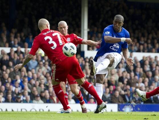 Sylvain Distin (R) of Everton takes a shot on goal past Martin Skrtel (C) and Jose Baxter of Liverpool Barclays Premier League Everton FC vs. Liverpool FC 17th October, 2010 EDITORIAL USE ONLY. No use with unauthorised audio, video, data, fixture lists, club league logos or live services. Online in-match use limited to 120 images, no video emulation. No use in betting, games or single club league player publications.