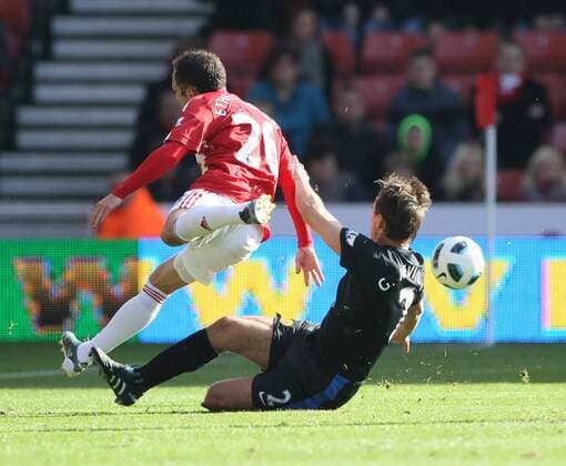 Stokes Matthew Etherington gets brought down by Manchester Uniteds Gary Neville --- Barclays Premier League - Stoke City (red stripes) vs Manchester United (ManU black), 24th October, 2010 EDITORIAL USE ONLY. No use with unauthorised audio, video, data, fixture lists, club league logos or live services. Online in-match use limited to 120 images, no video emulation. No use in betting, games or single club league player publications.