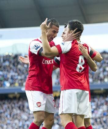 Samir Nasri (R) of Arsenal celebrates scoring his goal with Cesc Fabregas (C) of Arsenal and Marouane Chamakh of Arsenal - Barclays Premier League, Manchester City (blue) v FC Arsenal (red)24th October, 2010 EDITORIAL USE ONLY. No use with unauthorised audio, video, data, fixture lists, club league logos or live services. Online in-match use limited to 120 images, no video emulation. No use in betting, games or single club league player publications.