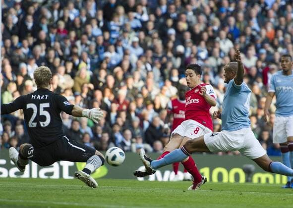 Samir Nasri of Arsenal scores the first goal past Joe Hart of Manchester City as Vincent Kompany of Manchester City dives in - Barclays Premier League, Manchester City (blue) v FC Arsenal (red)24th October, 2010 EDITORIAL USE ONLY. No use with unauthorised audio, video, data, fixture lists, club league logos or live services. Online in-match use limited to 120 images, no video emulation. No use in betting, games or single club league player publications.