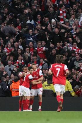 Premier League - Manchester City vs. Arsenal FC London - Nicklas Bendtner (2.R) and Samir Nasri (Arsenal, 2.L) celebrates in front of the away fans at the City of Manchester Stadium 
