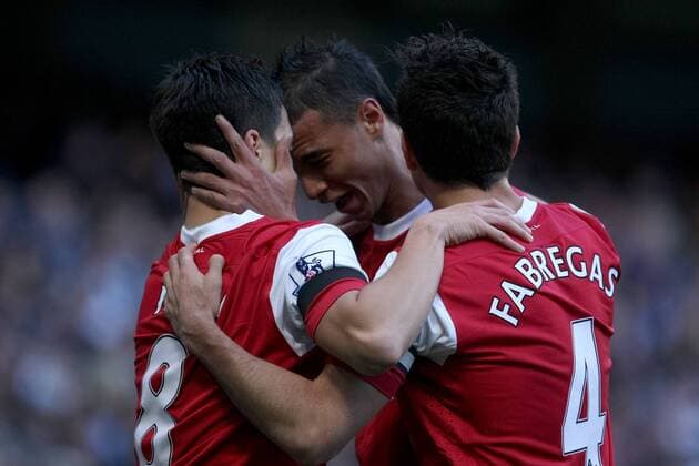 Premier League - Manchester City vs. Arsenal FC London - Arsenal s Marouane Chamakh (C) celebrates the opening goal with Cesc Fabregas (R) and goal scorer Samir Nasri at the City of Manchester Stadium 