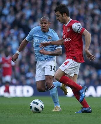 Premier League - Manchester City vs. Arsenal FC London - Nigel de Jong (L) of Manchester City and Arsenal s Cesc Fabregas in action at the City of Manchester Stadium 