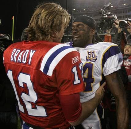Minnesota Vikings wide receiver Randy Moss gives a hug to his former teammate, New England Patriots quarterback Tom Brady at the end of the game in Foxboro, Massachusetts  BOS2010103119
