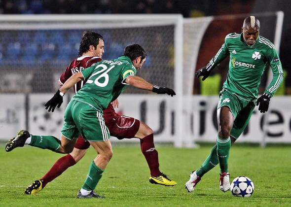 KAZAN, RUSSIA. NOVEMBER 2, 2010. Rubin s Alana Kasaev and Panathinaikos Giorgos Karagounis and Djibril Cisse (L to R) seen during an UEFA Champions League match between Rubin Kazan and Panathinaikos Athens. The match ends in a 0-0 draw.  RE0DB10C