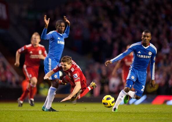 Ramires of Chelsea (front L) brings down Steven Gerrard of Liverpool (C) - Liverpool FC vs. Chelsea FC EDITORIAL USE ONLY. No use with unauthorised audio, video, data, fixture lists, club league logos or live services. Online in-match use limited to 120 images, no video emulation. No use in betting, games or single club league player publications.