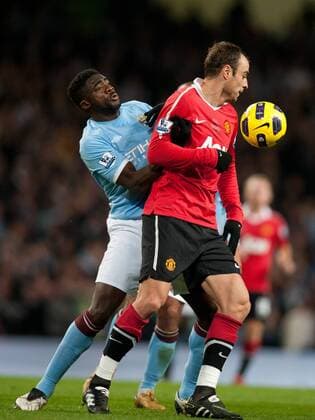 Kolo Toure of Manchester City and Dimitar Berbatov of Manchester United (red) scrap for the ball - Premier League Manchester City v Manchester United (red) 10th November, 2010 EDITORIAL USE ONLY. No use with unauthorised audio, video, data, fixture lists, club league logos or live services. Online in-match use limited to 120 images, no video emulation. No use in betting, games or single club league player publications. o0 Manu