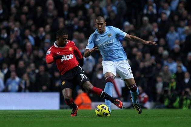 Football - Premier League - Manchester City (blue) vs. Manchester United (Manu): Patrice Evra of Manchester United and Jerome Boateng of Manchester City in action at the City of Manchester Stadium 