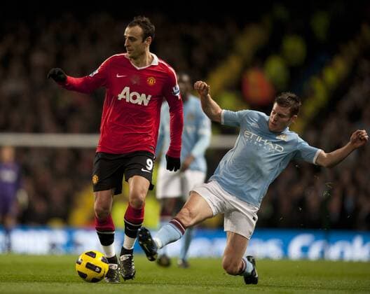 Dimitar Berbatov of Manchester United tackled by James Milner of Manchester City - Premier League Manchester City v Manchester United 10th November, 2010 EDITORIAL USE ONLY. No use with unauthorised audio, video, data, fixture lists, club league logos or live services. Online in-match use limited to 120 images, no video emulation. No use in betting, games or single club league player publications. o0 manu