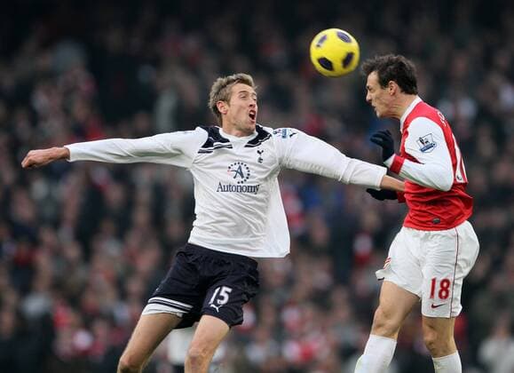 Arsenals Sebastien Squillaci tussles with Tottenhams Peter Crouch --- Barclays Premier League, Arsenal (red) v Tottenham Hotspur (white) 20th November, 2010 EDITORIAL USE ONLY. No use with unauthorised audio, video, data, fixture lists, club league logos or live services. Online in-match use limited to 120 images, no video emulation. No use in betting, games or single club league player publications.
