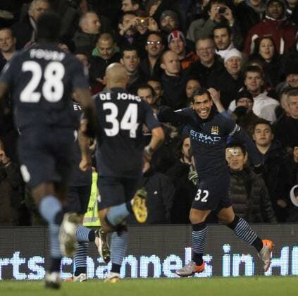 Manchester Citys Carlos Tevez (R) celebrates scoring his sides fourth goal - Fulham FC - Manchester City - EDITORIAL USE ONLY. No use with unauthorised audio, video, data, fixture lists, club league logos or live services. Online in-match use limited to 120 images, no video emulation. No use in betting, games or single club league player publications.