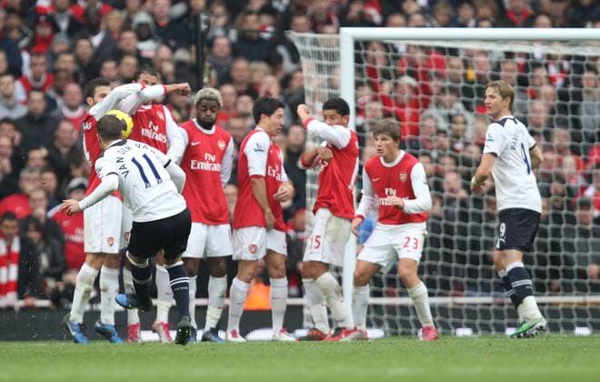Arsenal FC London - Tottenham Hotspur - Rafael van der Vaart (Tottenham, front) takes a free kick which hits Cesc Fabregas (L) arm to give a penalty.