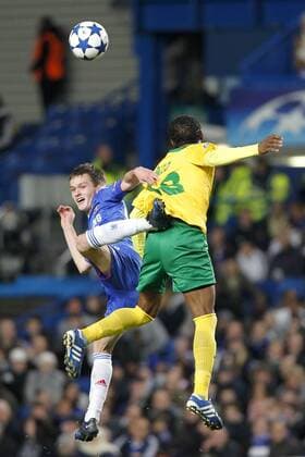 Football - Champions League - FC Chelsea (blue) vs. MSK Zilina (yellow) --- Chelsea s Josh McEachran and MSK Zilina s Babatounde Bello jump for the ball at Stamford Bridge  o0 Mc Eachran