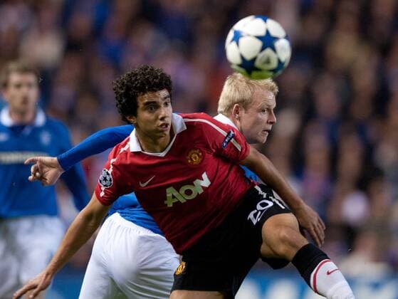 Fabio Da Silva of Manchester United challenged by Steven Naismith of Rangers - Champions League, Glasgow Rangers (blue) vs. Manchester United (red) 24th November, 2010 EDITORIAL USE ONLY. No use with unauthorised audio, video, data, fixture lists, club league logos or live services. Online in-match use limited to 120 images, no video emulation. No use in betting, games or single club league player publications. o0 Manu